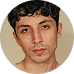 A close-up portrait of a young male gamer with a serious expression, representing a dedicated KuyaPlay user immersed in the gaming experience.