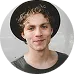 A friendly young man wearing a hat and smiling, symbolizing a member of the engaged and dynamic KuyaPlay gaming community.