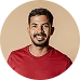 A friendly man in a red shirt smiles warmly against a neutral background, representing a satisfied and active member of the KuyaPlay gaming community.
