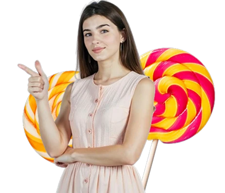 A young woman in a light pink dress confidently pointing sideways with two large colorful swirl lollipops behind her, all on a transparent background, promoting the playful and inviting atmosphere of KuyaPlay login
